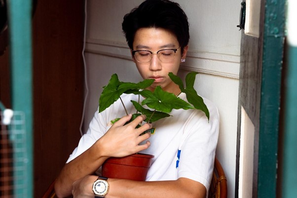 man-holding-potted-plant